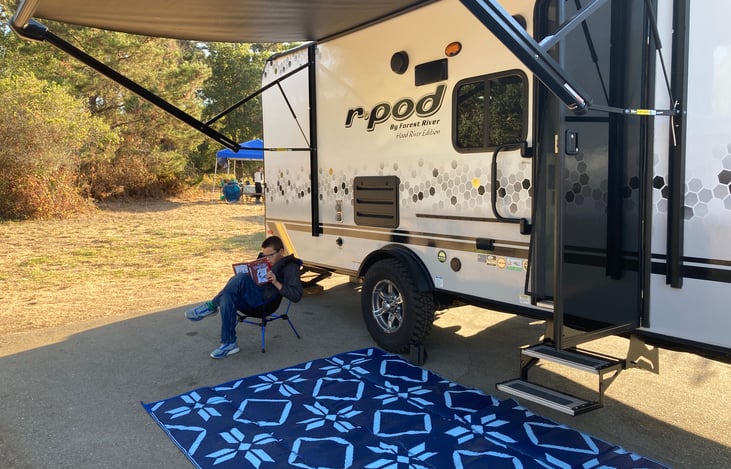 My boy reading his book under the shade palace