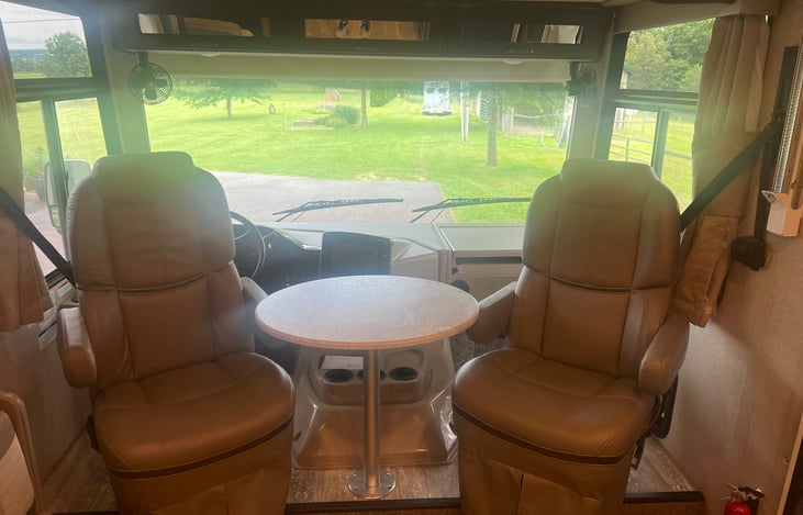 Driver seats convert to entertainment / living space with table.