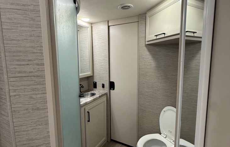 Full bathroom with closets, and a lock for the door