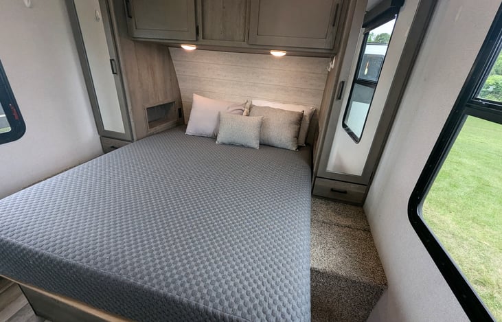 Cozy private bedroom with Queen bed. Ample storage and even a pet kennel is built in.
