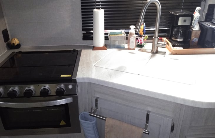 Gas oven and range. Large covered sink.