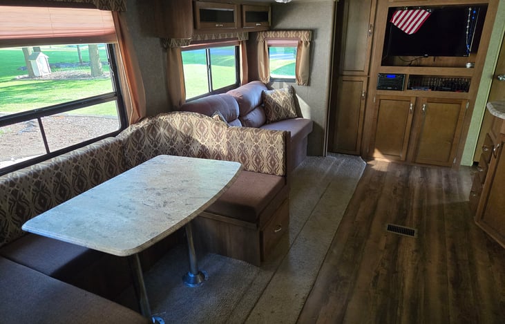 Dinette and couch both pull out into beds. Each will sleep one adult or two children.