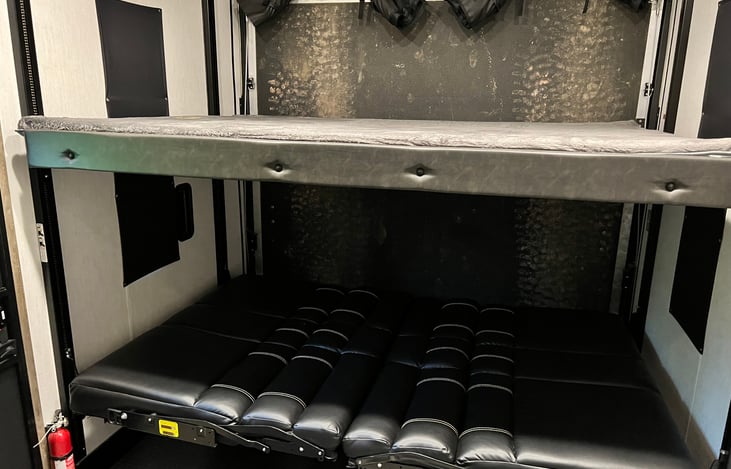 Top queen size bed and lower fold out benches that makes a bed