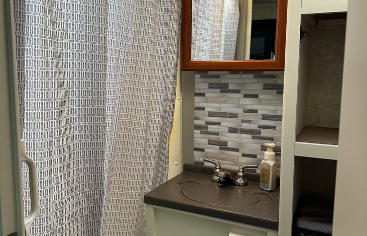 Bathroom comes equipped with fresh towels, camper toilet paper, and Bath and body Works hand soap.
