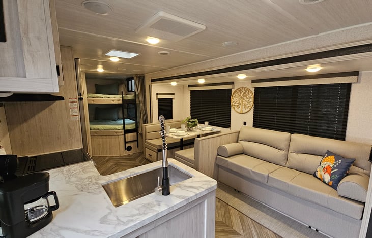 Living area with large bunks in the back. Linens are provided.