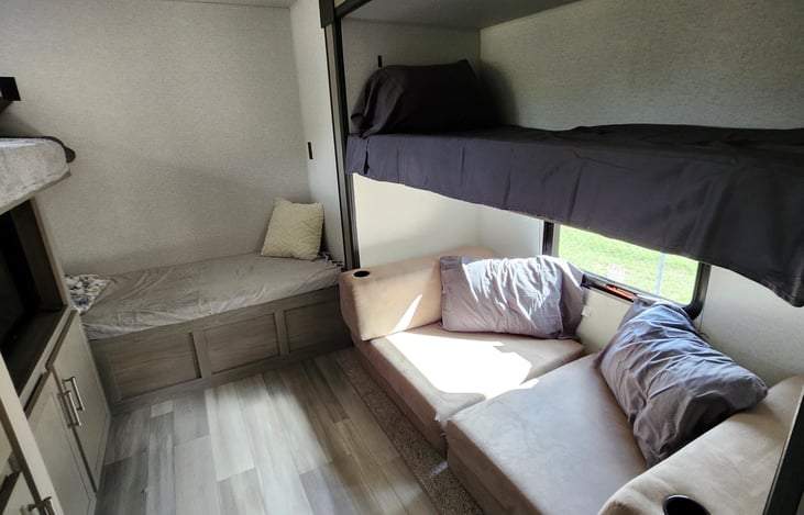 Seating area folds out to a double sleeping arrangement.