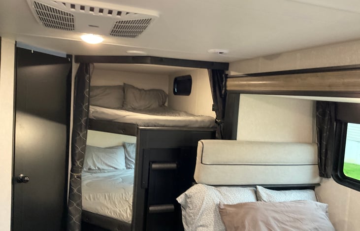 Double-bunk beds headroom comparison. The bathroom door is show to the left of the bunks.