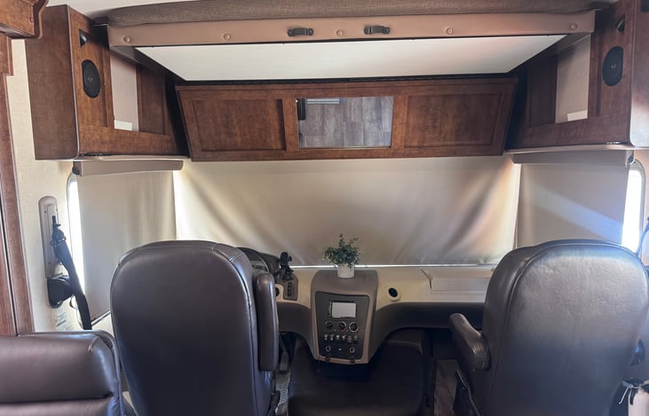 Driver’s and passenger seats. Over head drop down queen bed.