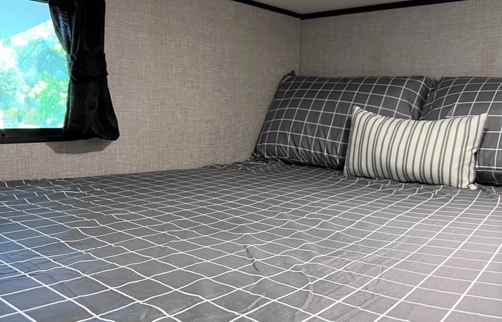 Window w/ view on top bunk.