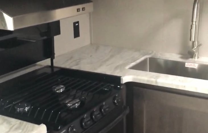 Complete CLEAN kitchen with stove/oven range, microwave oven, full sink with both hot and cold water hookup.