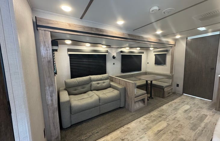 Dinette and sofa bed with overhead lights and lamp
Under bench storage