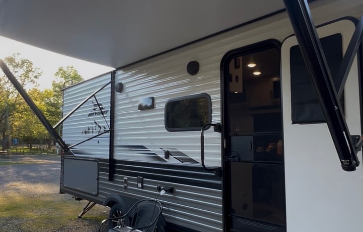 Enjoy the outdoor kitchen featuring a gas griddle, min fridge, exterior storage, TV connection and power outlets- perfect for outdoor dining, gaming and family gatherings.