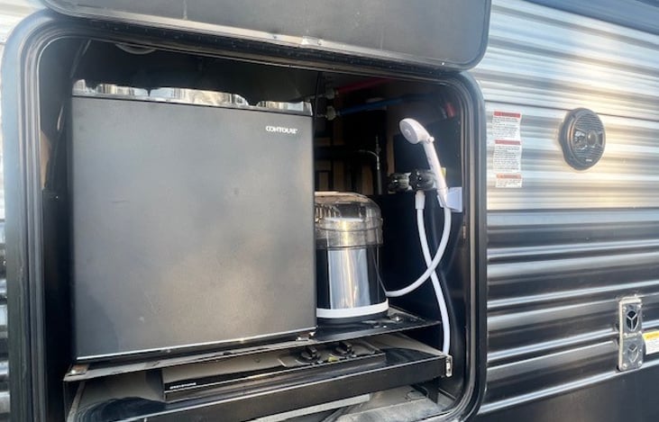 Outside Kitchen: water, mini fridge, two burner stove, ice maker.
