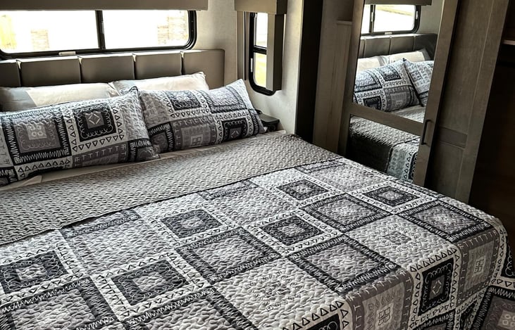 Very Comfortable custom King Size bed in primary bedroom.