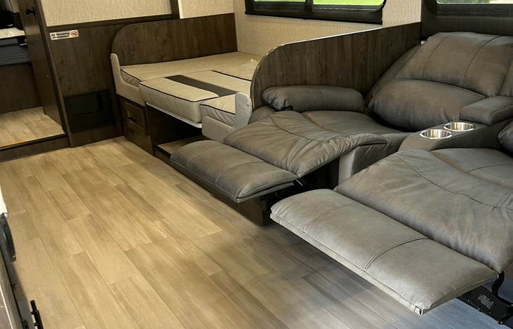 Dining room table bed, recliners fully extended.