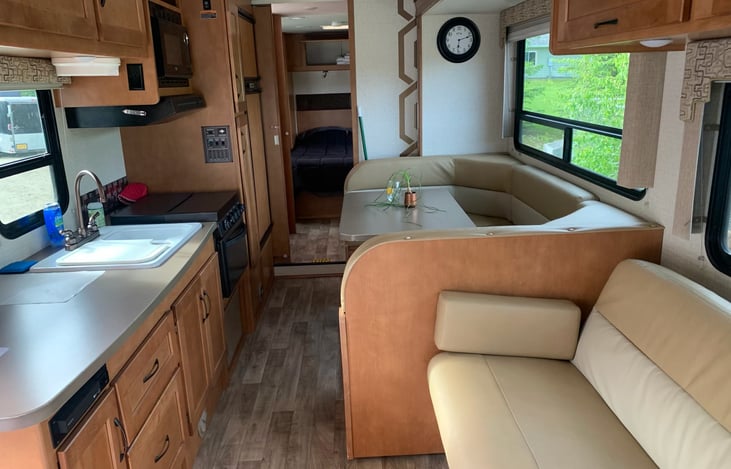 Slide IN. there is still lots of space.   Dinette and couch have seatbelts.  Microwave works with Generator on.  Fridge runs on propane or elec.