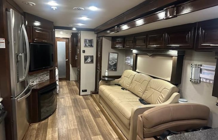 New Jack knife sleeper sofa with entertainment and cup holders in the middle, study tray and arm rest cup holders.