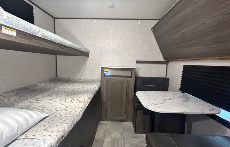 Bunk room with table and couches