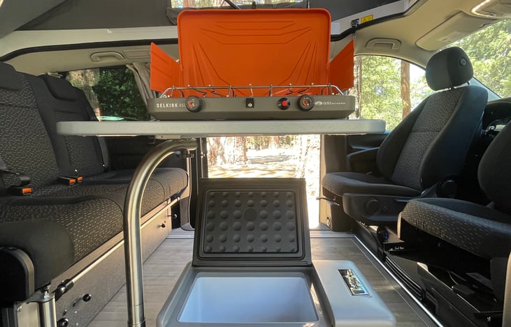 Propane two-burner stove and adjustable temp refrigerator. Fridge is able to freeze with adjustable temperature setting.