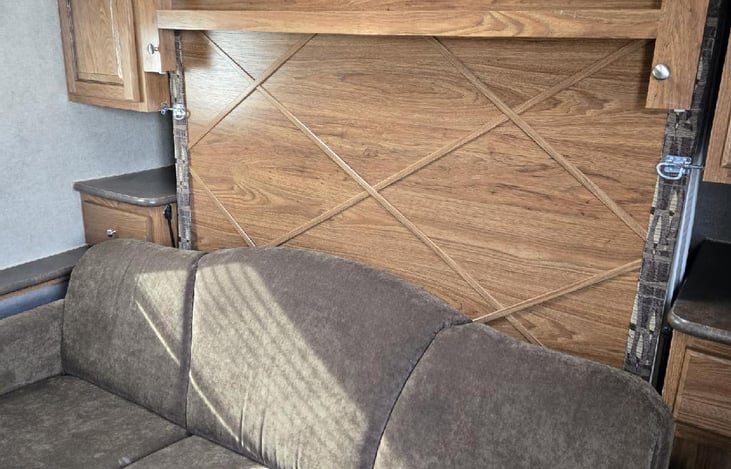 I love this bed. the couch is a jacknife couch and when opened the Murphy bed folds down.  No walking around a bed all day when your just chilling in the camper.