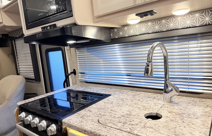 Kitchen with range and oven, microwave, pull-down faucet, big window