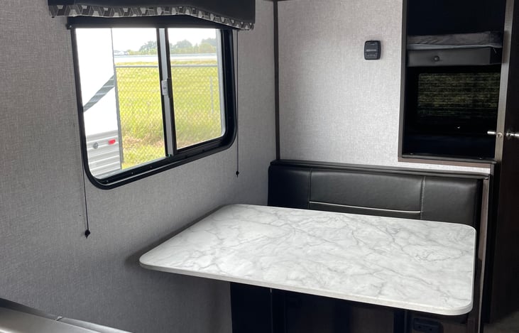 Dinette with under bench storage. Easily converts to a bed.