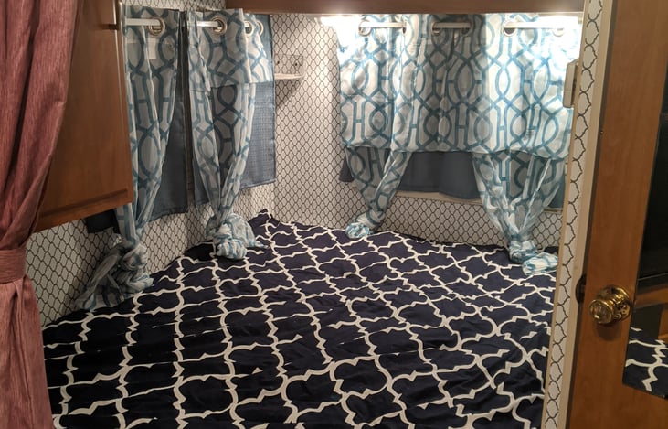 Comfy full size bed in private curtained nook.