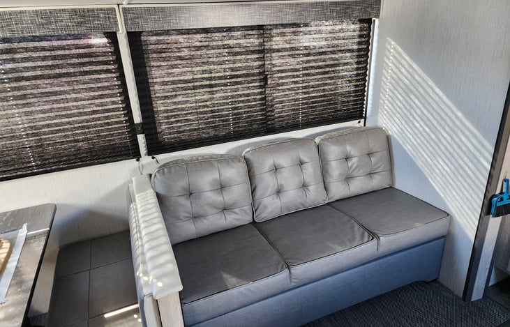 Three-person couch converts to a bed.