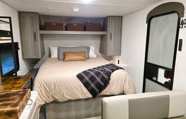 New queen-size mattress. Closets on either side. Storage under the bed and baskets above. Plenty of room to move in!