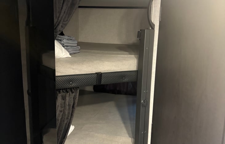Extra wide (45”) bunks with electronic plugins, pillows, linens and window.