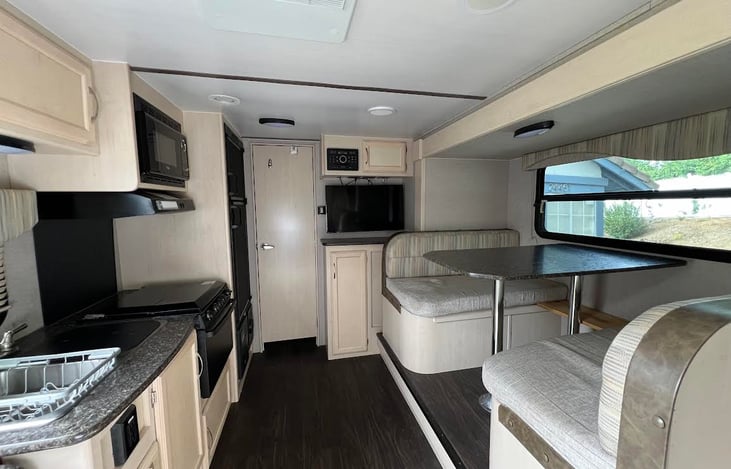 Inside trailer has plenty of room with the 30” electric dining slider pulled out.