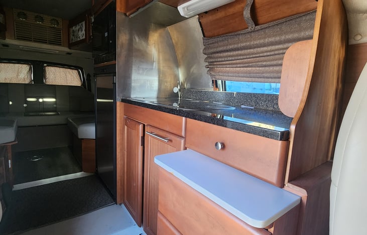 Gas stove, sink, coffee maker, utensils, plates, bowls, cups and anything else you need for a van life adventure.