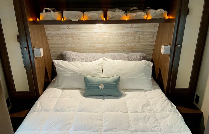 Comfy time! The little holders mounted to the wall are good for standard size water bottles or remote controls, or maybe your phone.