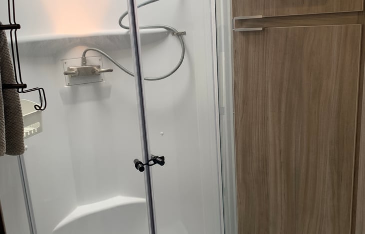 Shower with a conveniently located sky light to give an extra 4” of head room.