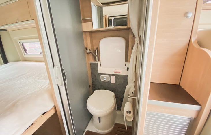 Bathroom with toilet, shower and fold down sink
