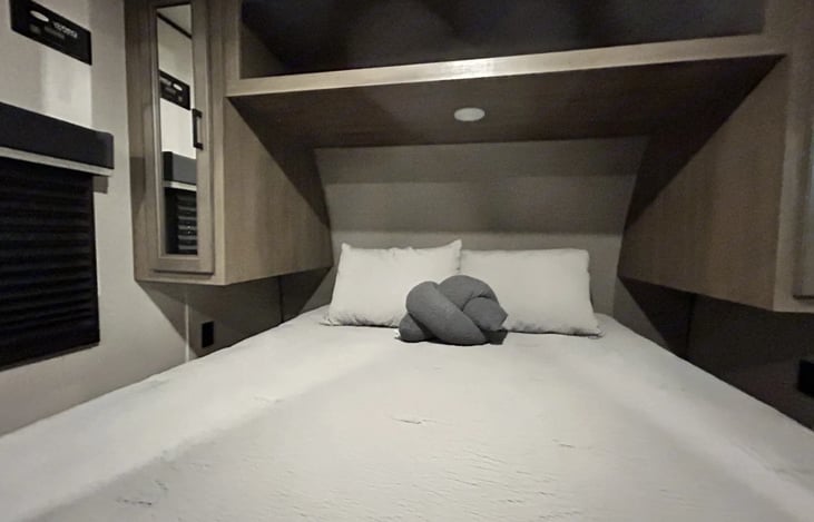 Private queen suite with double vanities and overhead storage