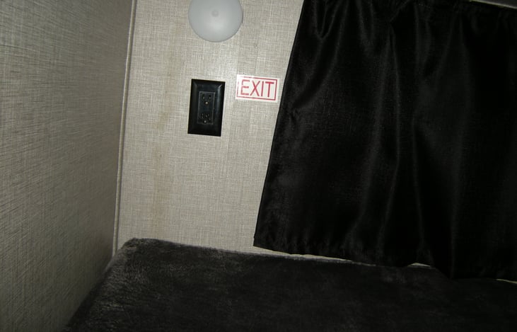 Full size bunks with a window, reading light, and charging station