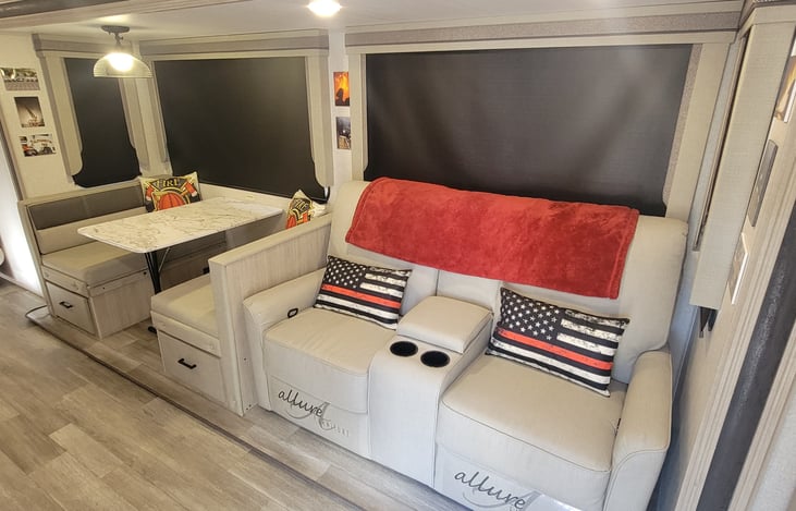 Double reclining love seat and standard convertible camper table that doubles as a bed.