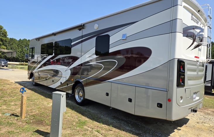 Rear view of RV and driver's side with living area slide out.