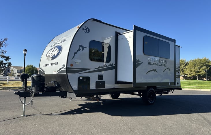 Front-quarter exterior with hitch, front cap, and compact trailer profile.