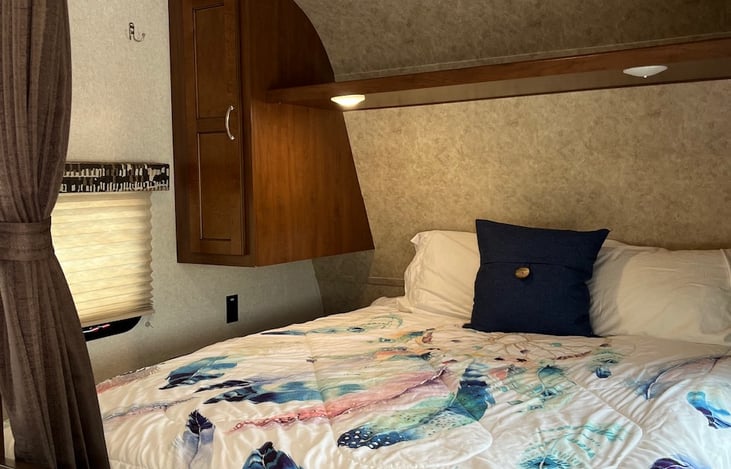 Nice Queen bed with ample storage. Privacy curtain allows guest to have space and a bit of separation.