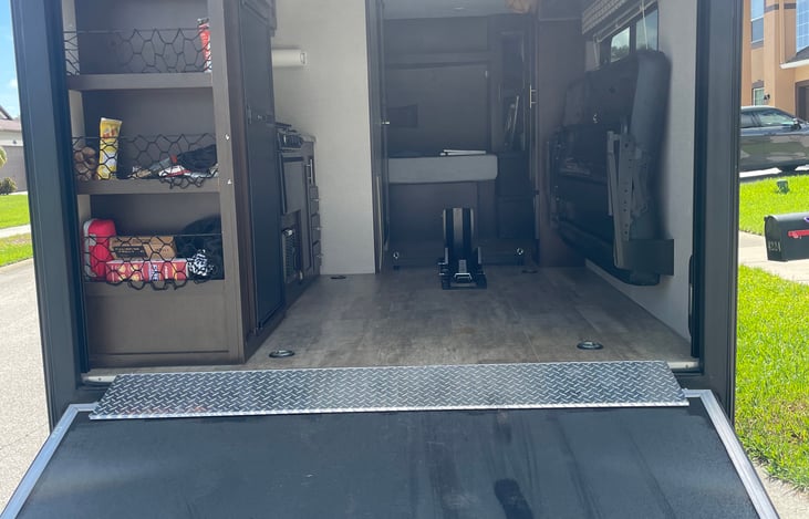 full view of storage for motorcycle or other items. Wheel chock bolts to the floor and is included if needed.