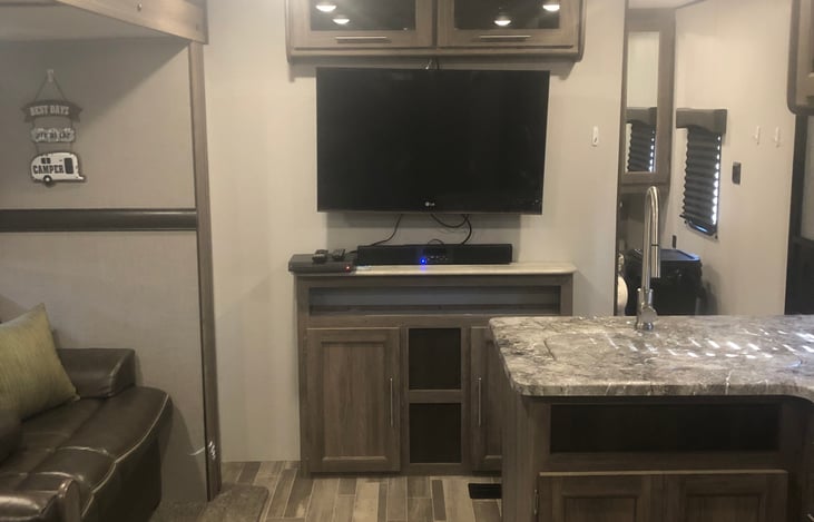 Entertainment Center with TV, DVD Player, and sound bar with AM/FM radio and blue tooth connection