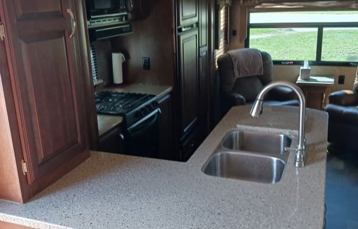 Wonderful Kitchen! Stainless steel sink with heavy duty counter tops. Microwave, LP stove top with oven.