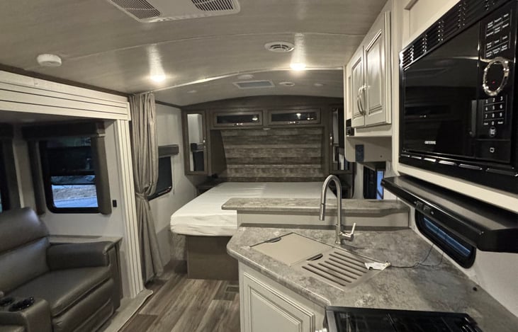 RV King Size bed with curtain to separate main area. Good sink with large faucet