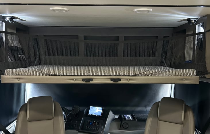 Overhead sleeping/storage area lowered.