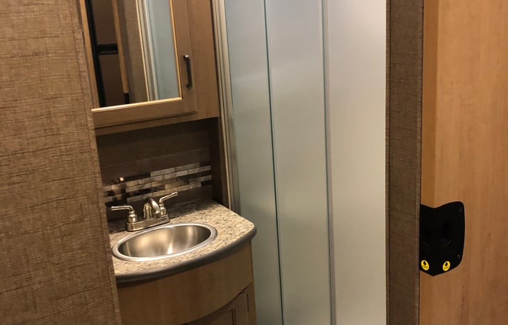 Bathroom- Shower, Sink, Toilet with Extra storage space.