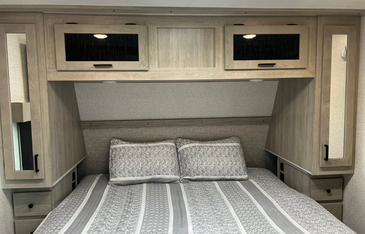 King size bed. Two small closets with drawers and overhead storage.