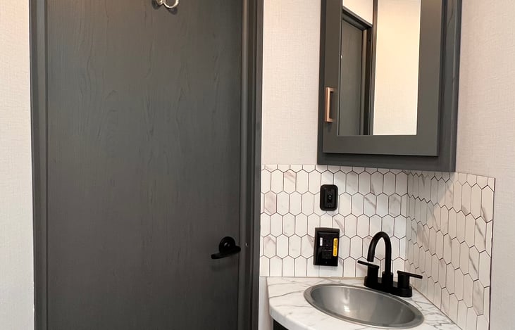 The bathroom is light and bright. RV-safe toilet paper is provided.