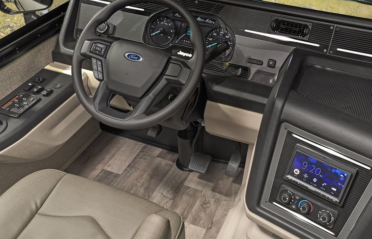 Passenger side does have a fold down table great for any work that needs to be done on the road laptop style.